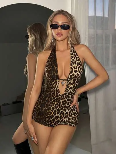 Woman in leopard print mini dress and sunglasses.